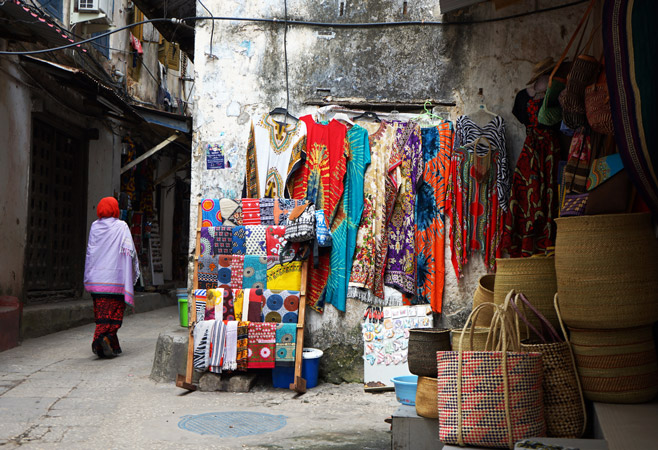 Kangas and Kikois - the brightly patterned fabrics worn by local women and men Kangas and Kikois - the brightly patterned fabrics worn by local women and men