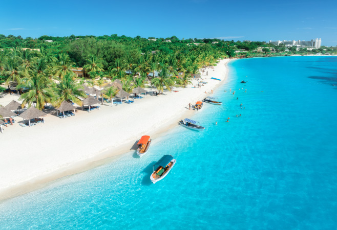 Kendwa Beach in Zanzibar is known for its stunning huge white sandy beach, and breathtaking sunset in the evening