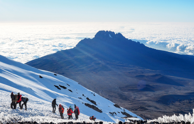 This volcanic massif stands in splendid isolation above the surrounding plains, with its snowy peak looming over the savannah This volcanic massif stands in splendid isolation above the surrounding plains, with its snowy peak looming over the savannah