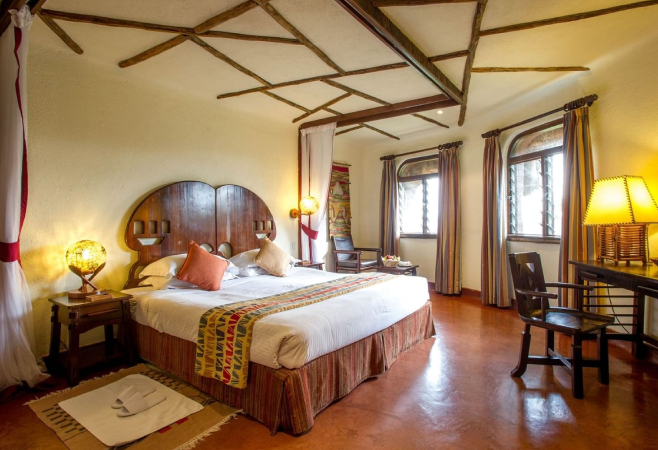 Serengeti Serena Safari Lodge blends into an acacia-lined ridge. African-style lodge, infinity pool, and panoramic views across the Serengeti plains